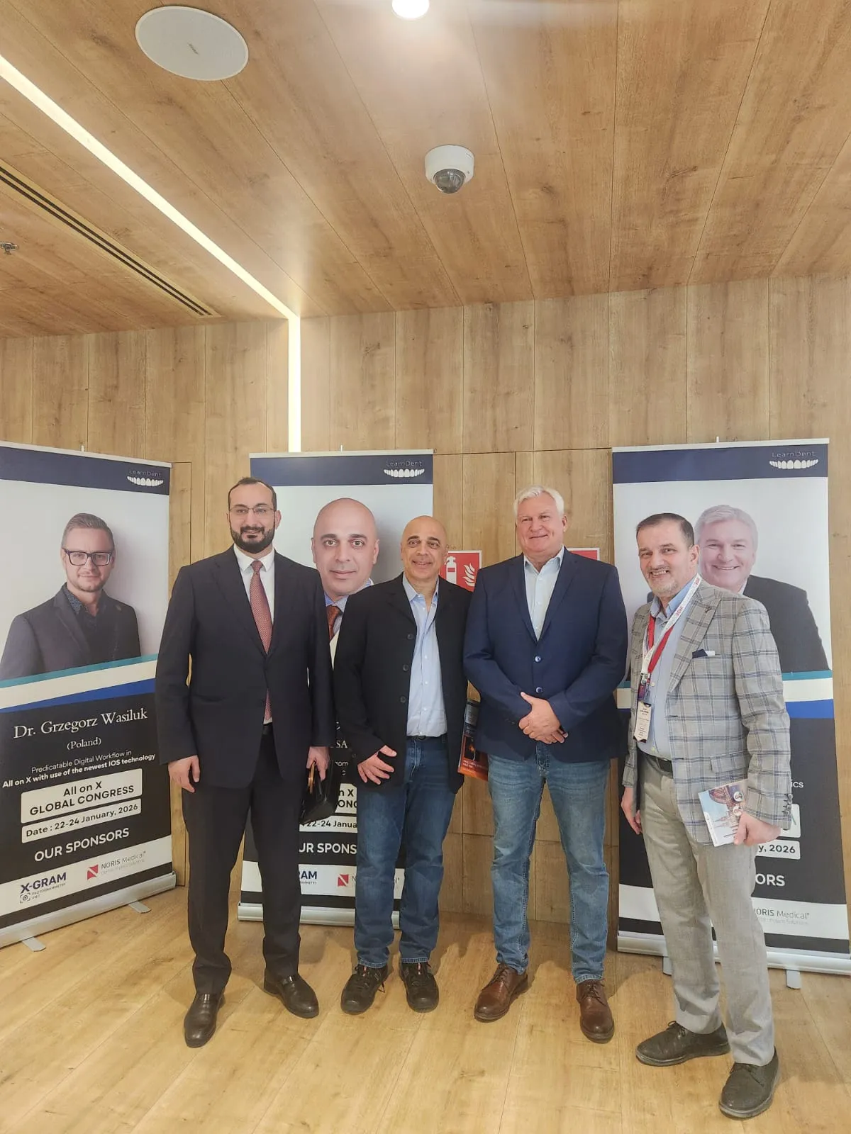 Dr. Nabeel (right) with Dr. Paulo Malo, creator of the All-on-4 concept (second from right), and fellow clinicians at the All on X Global Congress, January 2026.